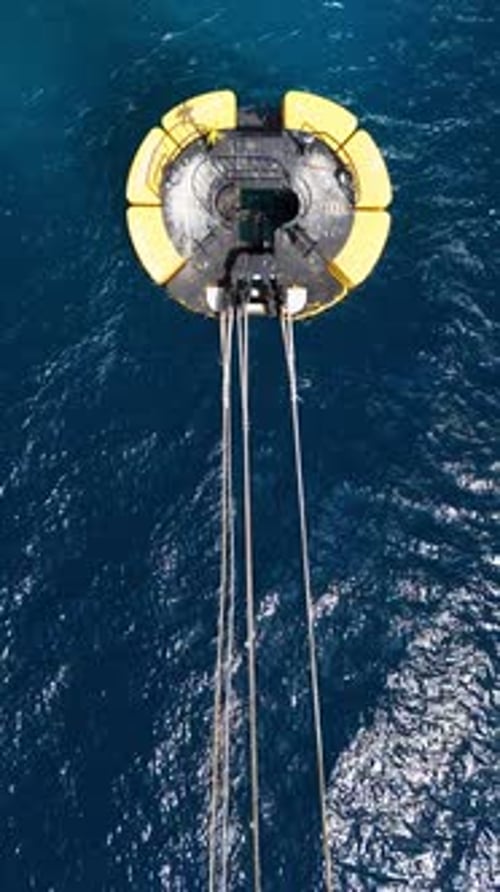 Drone top down shot on yellow mooring buoy in deep blue Caribbean ocean, small waves and wind ripple