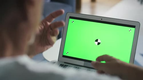 Typing on Laptop with Green Screen Display
