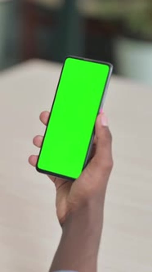 Young African Man Using Smartphone with Green Screen, Vertical Video