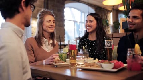Friends Toasting Drinks at Bar Party