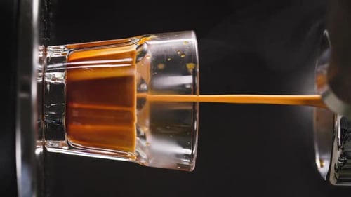 Espresso Pouring into Glass from Machine