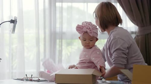 Happy Asian Women Online Seller Doing Live Broadcast with Baby