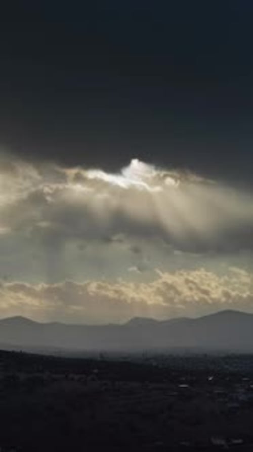 Moving sunbeams and mountain landscape