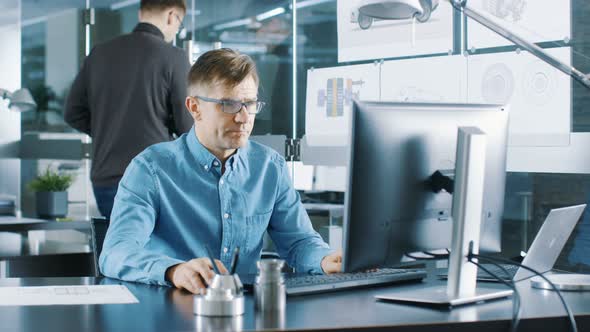 Experienced Industrial Engineer Working on Personal Computer in the ...