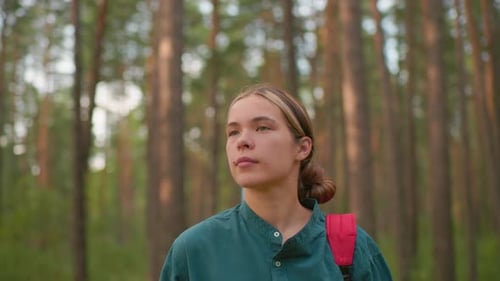 Young Woman Hiking Through Serene Forest Trail with Friend