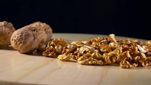 Delicious Shelled Walnuts on Rotating Wood Surface