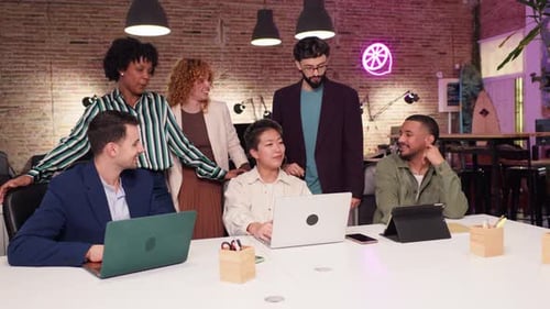 Coworkers Collaborating on Project in Modern Office in Slow Motion