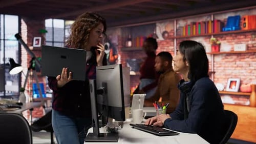 Tech Team Discussing Project in Modern Office