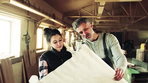 Man and Woman Workers in the Carpentry Workshop