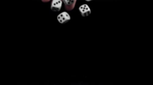 Hand Dropping Dice onto a Black Surface