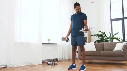 Man Lifting Dumbbells in Bright, Airy Living Room