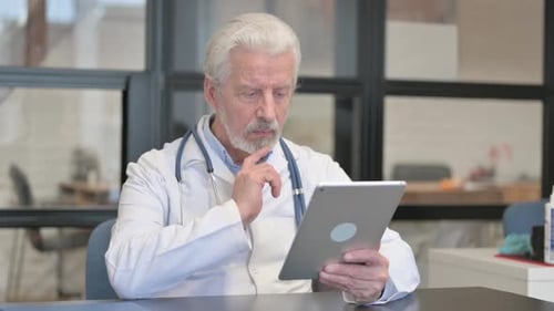 Senior Doctor Using Tablet in Office Setting