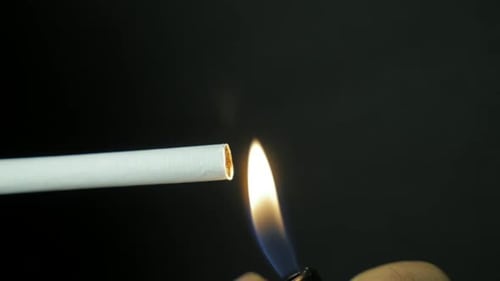 Closeup of Lighting a Cigarette Highlighting the Details and Risks of Smoking