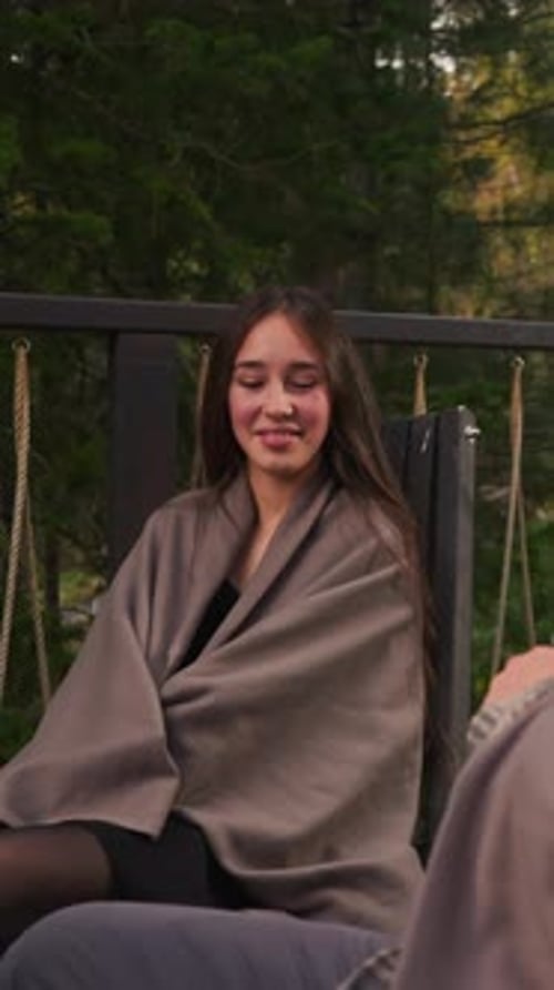 Couple Wraps with Blankets on Glamping Terrace