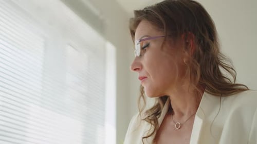 Woman Massaging Temples After Removing Glasses