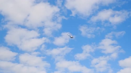 Helicopter flying by blue sky