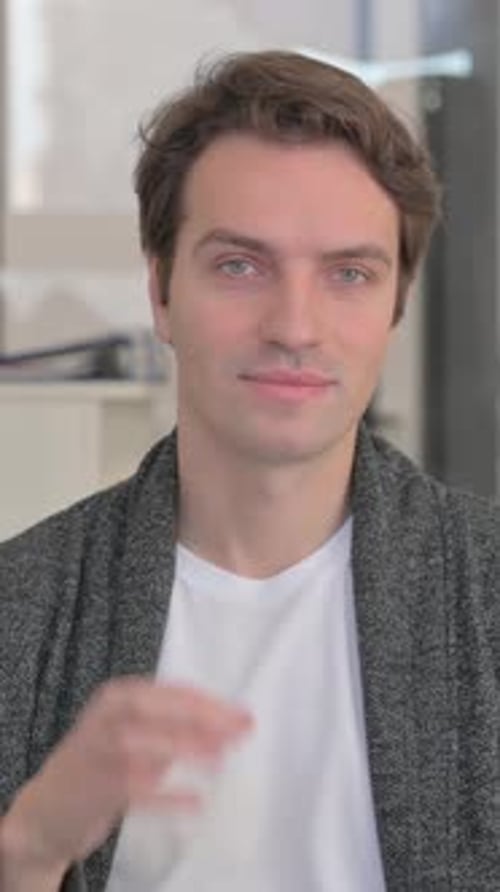 Man Gives Okay Sign with Hand and Smiles