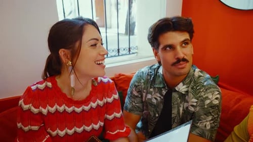 Waiter recommending menu specials to friends in a restaurant