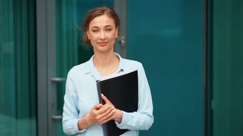 Smiling Businesswoman Offering Handshake Outside Office Building