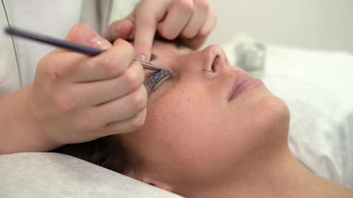 Woman Receives Eyelash Treatment Application