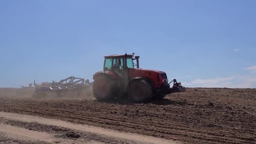 Tractor on the Farmer's Field Plows and Cultivates the Soil Agriculture Farming Business Harvest