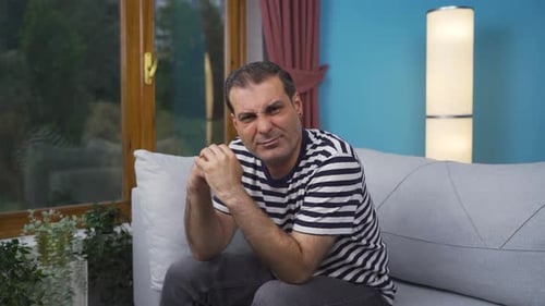 Man looking negative at camera. Negative-looking man.