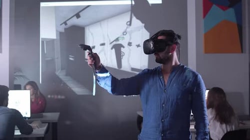 Man Uses VR Headset in Modern Office Setting