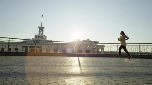 A Beautiful Chubby Woman is Doing Cardio Training on a Run in the Morning