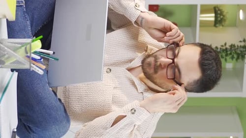 Man Working from Home on Laptop, Taking Notes