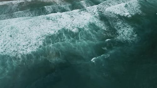 Aerial view of crashing waves along the coast, United States.