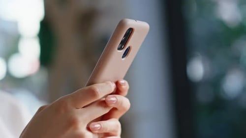 Close up of woman using cell phone indoors