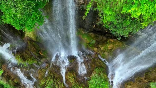 Beautiful waterfall in a tropical forest by aerial view from a drone.