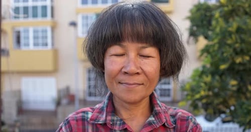 Smiling Woman Close-up Outside in front of Building