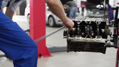 Mechanic Overhauls Engine Disassembles Cylinder Block Extracts Crankshaft in Workshop Auto Repair