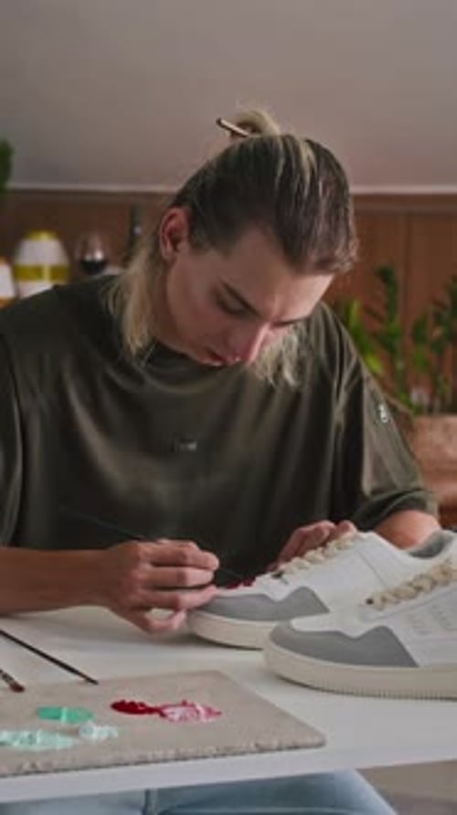 Stylist Making Custom Sneakers in Fashion Studio