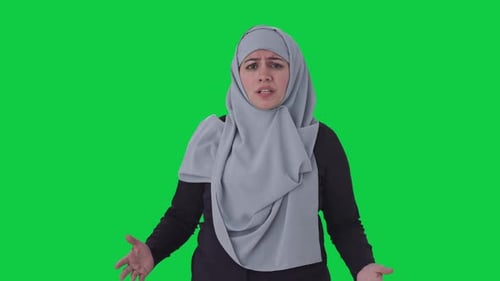 Angry Muslim woman talking to the camera Green screen