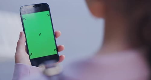 Woman, hands and phone with green screen tracking markers for advertising or marketing in the city