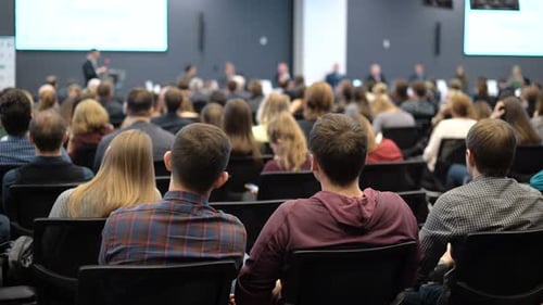 Corporate Conference Audience Listening to Speaker Presentation