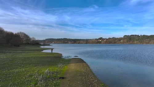 Flying Towards Travel Photographer Capturing Lake Scenery In Daytime. drone shot