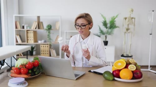 Woman Doctor Explaining Pills with Fresh Vegetables and Fruits