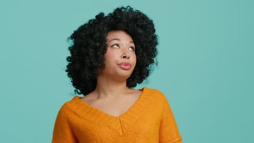 Woman with Curly Hair Poses in Studio Setting