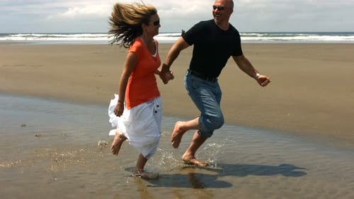 Couple Run on Beach Together,
