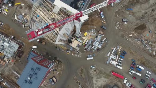 Top down aerial view of a construction site with cranes and unfinished buildings