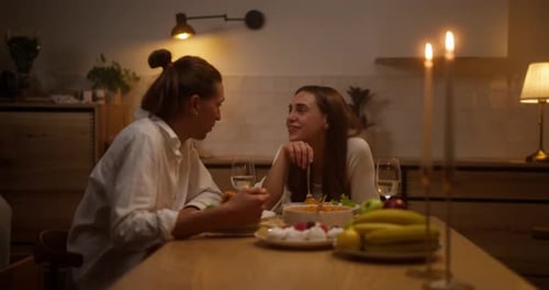 Uma garota alegre e feliz olha para o namorado e se comunica com ele durante uma noite romântica