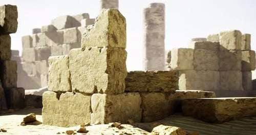 Ancient Stone Ruins Amidst Sandy Landscape in Bright Sunlight