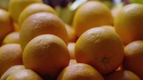 Closeup View of a Vibrant Pile of Ripe Oranges with Textured Dimpled Peels Showcasing Fresh Citrus