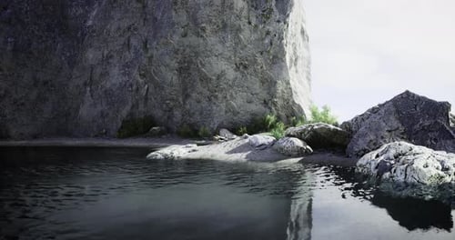 Serene Coastal Landscape with Rocky Cliff and Calm Waters at Midday