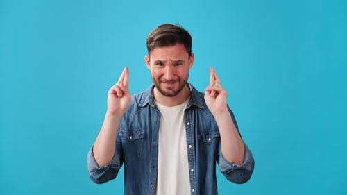 Man Celebrating Good News on a Blue Background