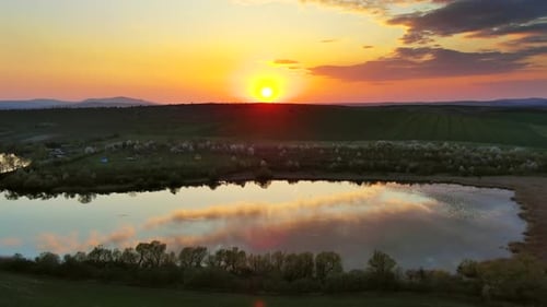 Sunset Wavy Hills with Fields and Pond