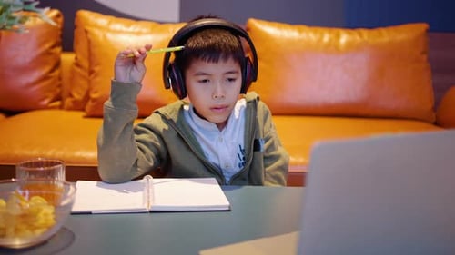 Boy Studying Online with Laptop and Headphones